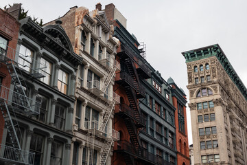 Row of Colorful Old Buildings in SoHo of New York City with Fire Escapes