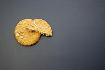 Round oatmeal cookies on a gray background.
