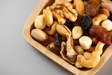  Mixed nuts in a bamboo plate. Healthy food concept.