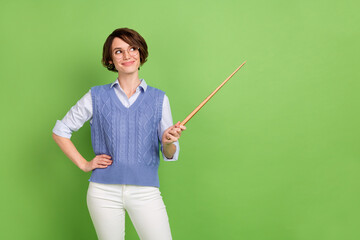 Photo portrait of cheerful curious student keeping wooden pointer showing blank space isolated...