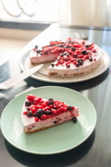Greek yogurt berry birthday cake and champagne for kids on a dark caffe table