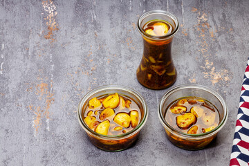 Glass jars with garlic cloves pickles with copy space. Healthy food preservation. Natural medicine.
