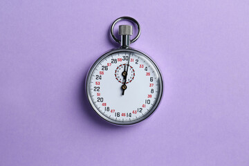 Vintage timer on violet background, top view