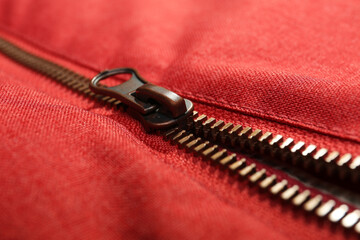 Red fabric with zipper as background, closeup view
