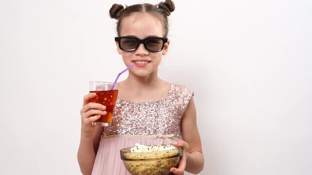 teen girl with glasses to watch funny 3D movies eats popcorn and drinks soda