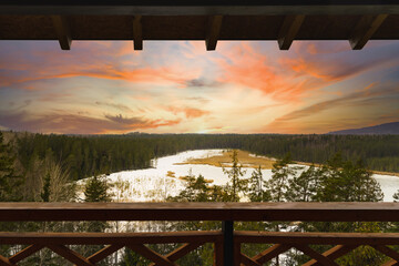 View from watchtower in a park, white beautiful sunset and frozen lake.