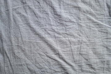 background with crumpled gray bed texture