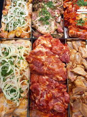 Fresh, marinated meat for barbecue. Appetizing kebabs, raw meat, on