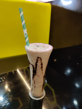 Sweet juice with strow on the table