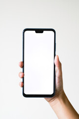 Business concept : Young man holding smartphone with blank screen on white background, closeup of hand, advertising text selling marketing products, mock up, Space for text.