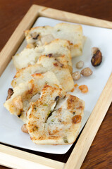 The delicious fried  turnip cake with black soy sauce. Dim Sum of turnip cake Chinese cuisine. Chinese traditional local dish radish cake. Chinese new year food.