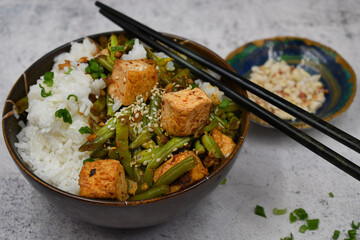 Vegan japanese tofu and beans stir fry served with rice