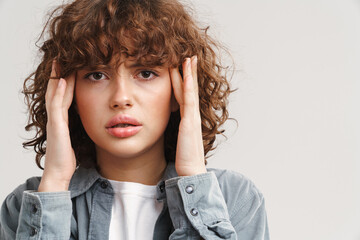 Ginger unhappy woman with headache rubbing her temples