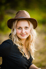 blonde girl in black dress with suitcase, selective focus