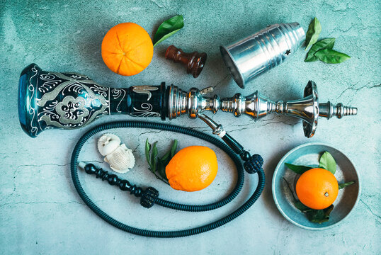 Hookah with oranges and Egyptian amulet in the shape of a scarab
