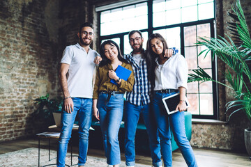 Obraz premium Positive diverse colleagues looking at camera