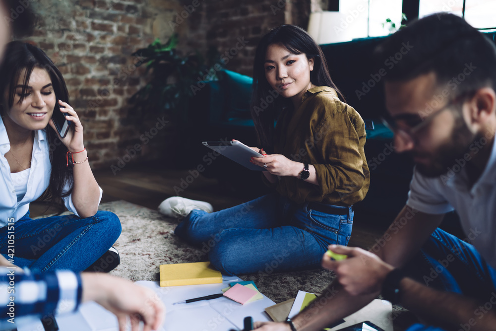 Wall mural diverse students discussing homework together in living room