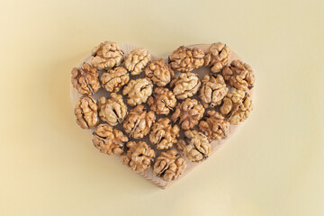 Organic walnuts are shaped like a heart. Healthy food for the heart, useful microelements and vitamins. Useful snack for vegetarians and more.