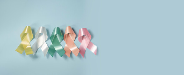 World cancer day, National cancer survivor day, cancer awareness, world autism awareness day,  World Down Syndrome Day, Colorful ribbons on pastel blue background