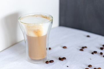 A double glass cup of cappuccino 