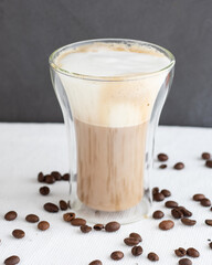 A double glass cup of cappuccino 