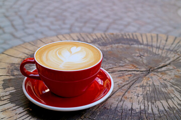 Cup of Hot Cappuccino Coffee Isolated on Tree Stump Table