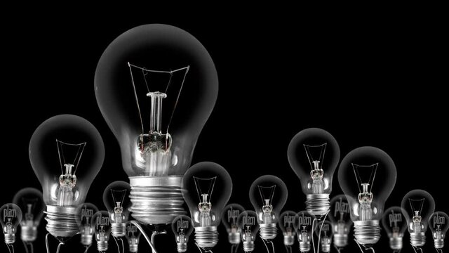 Light bulbs going from dark to light with Plan and Action fiber text on black background. High quality 4k video