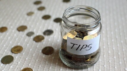 3D illustration - Coins filling in jar labeled for tips