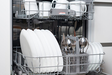 Full load dishwashing machine. Clean dishes and cutlery
