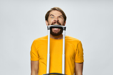  nervous man awaits a plane and a suitcase in his mouth