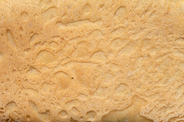 porous texture of a crust of bread, background