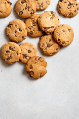 Chocolate cookies on a gray concrete background top view. Free space for text. Cookies background.