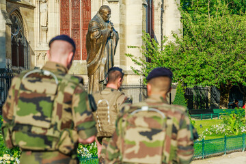PARIS, FRANCE - JULY 1, 2017: Pope John Paul II statue guarding soldiers of National Armed Forces...