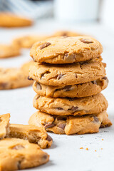 Heap of chocolate chip cookies on a gray table close-up. Sweet breakfast. Stack of traditional chip cookies with chocolate chunks.