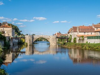 Obraz premium reflection of the bridge in the river Gartempe in Montmorillon France