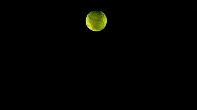 Super Slow Motion Of Hitting Tenis Ball With Rocket On Black Background.