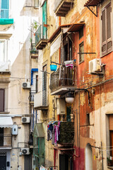 Fototapeta na wymiar Facade of classic buildings with hanging clothes in Naples, Italy
