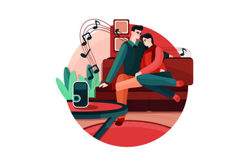 Couple sitting on the sofa listening to music on a wireless speaker