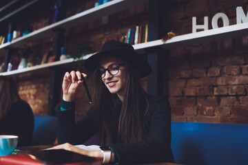 Cheerful woman with pen and notebook