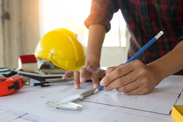 team Engineer and Architect consult projct with blueprint  at Construction Site