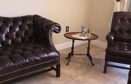 Traditional Chesterfield Sofa Couch And Armchair With A Small Vintage Round Table.