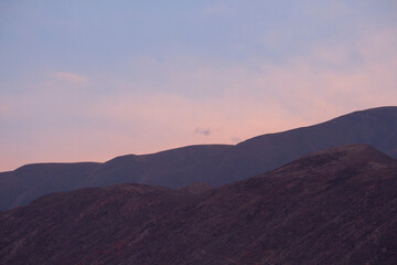 Obraz premium Enchanting landscape background. View of the mountains at sunset with a beautiful dusk light and colors. 
