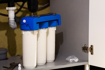 Water filter cartridges in the kitchen. Drinking water filtration system in the kitchen. Clean...