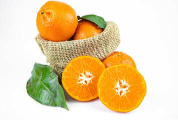 Ripe fresh juicy tangerines with leaves on white background
