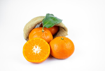 Ripe fresh juicy tangerines with leaves on white background