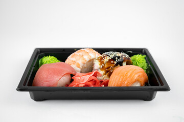 take away sushi in plastic container, pink ginger, wasabi. sushi delivery concept