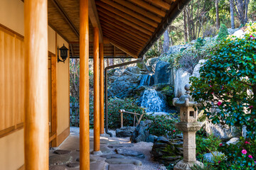 Wonderful view from the porch of the house to the Japanese-style garden on the mountain with a stone lantern and a stream