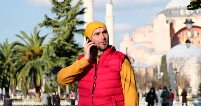 traveler in istanbul, turkey, talking on the phone, mosque