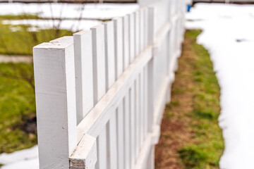Beautiful white garden fence made of wood close up