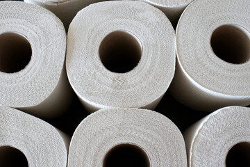 Multiple rolls of toilet paper stacked next to each other